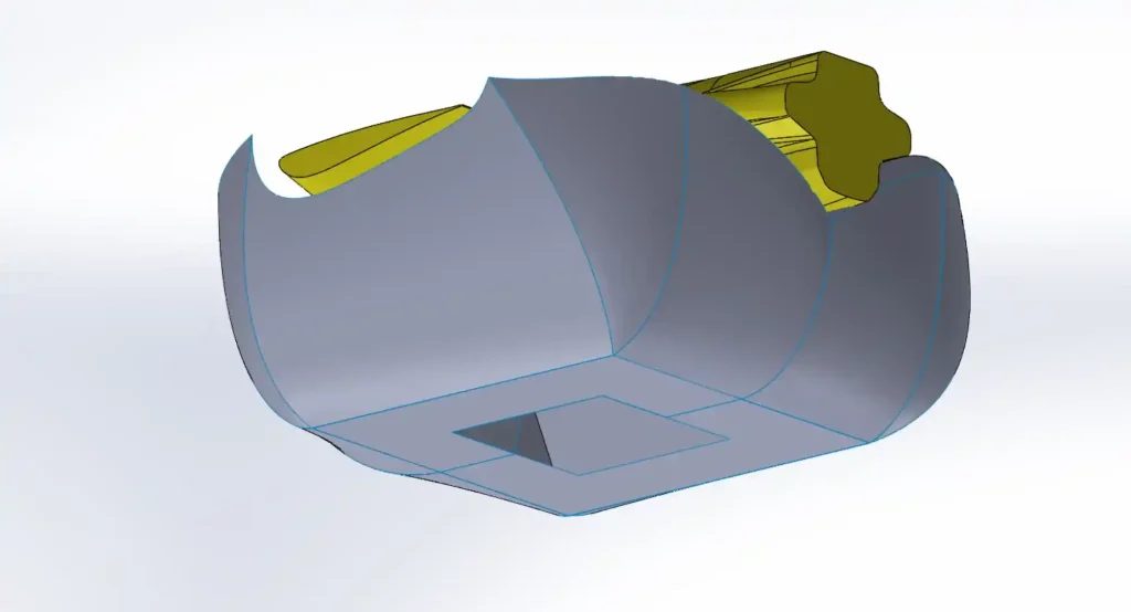 Modello CAD di un airbag con l'apertura della ventola sul lato inferiore e un componente evidenziato in giallo sopra
